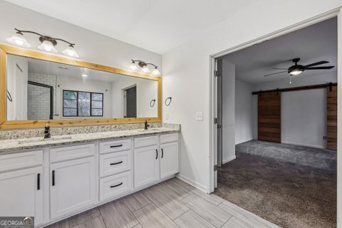 2562 Farley Street East Point, GA 30344 - Photo 18 of 30 a bathroom with a granite countertop sink vanity and mirror