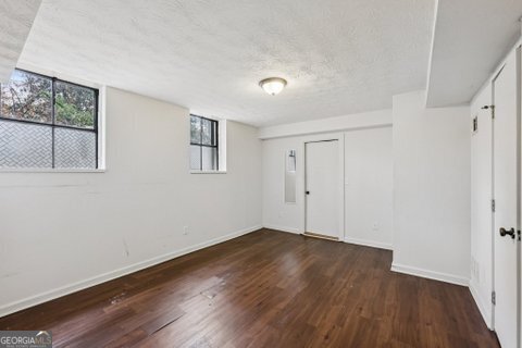 2562 Farley Street East Point, GA 30344 - Photo 23 of 30 a view of an empty room with wooden floor and a window
