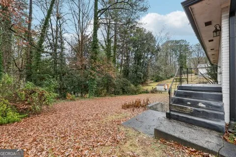 a view of backyard with wooden fence