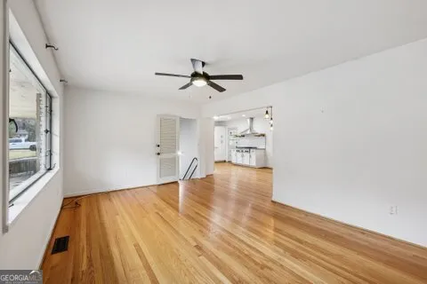 wooden floor in an empty room with a window