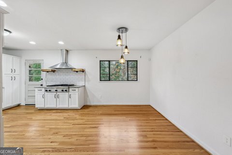 2562 Farley Street East Point, GA 30344 - Photo 7 of 30 a kitchen with stainless steel appliances granite countertop a stove a sink and a refrigerator