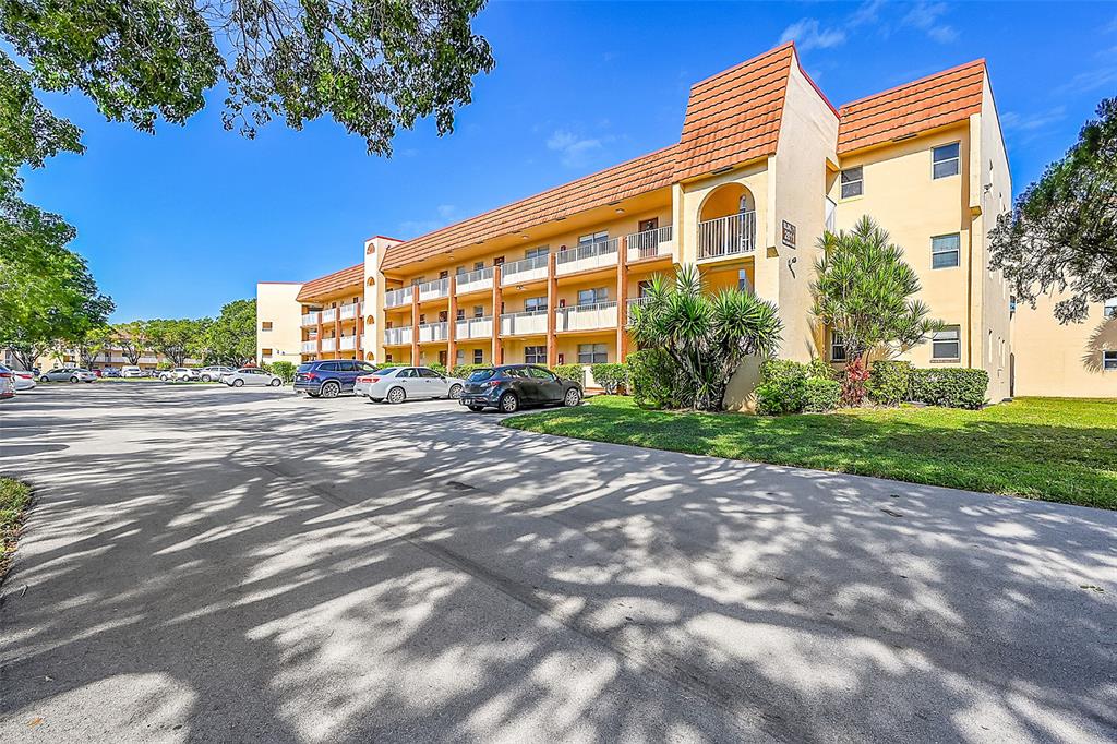 2811 North Pine Island Road, Unit 111 Sunrise, FL 33322 - Photo 3 of 13 a view of a house with a yard