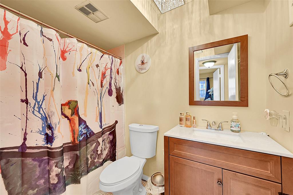 2811 North Pine Island Road, Unit 111 Sunrise, FL 33322 - Photo 4 of 13 a bathroom with a toilet a sink and a mirror
