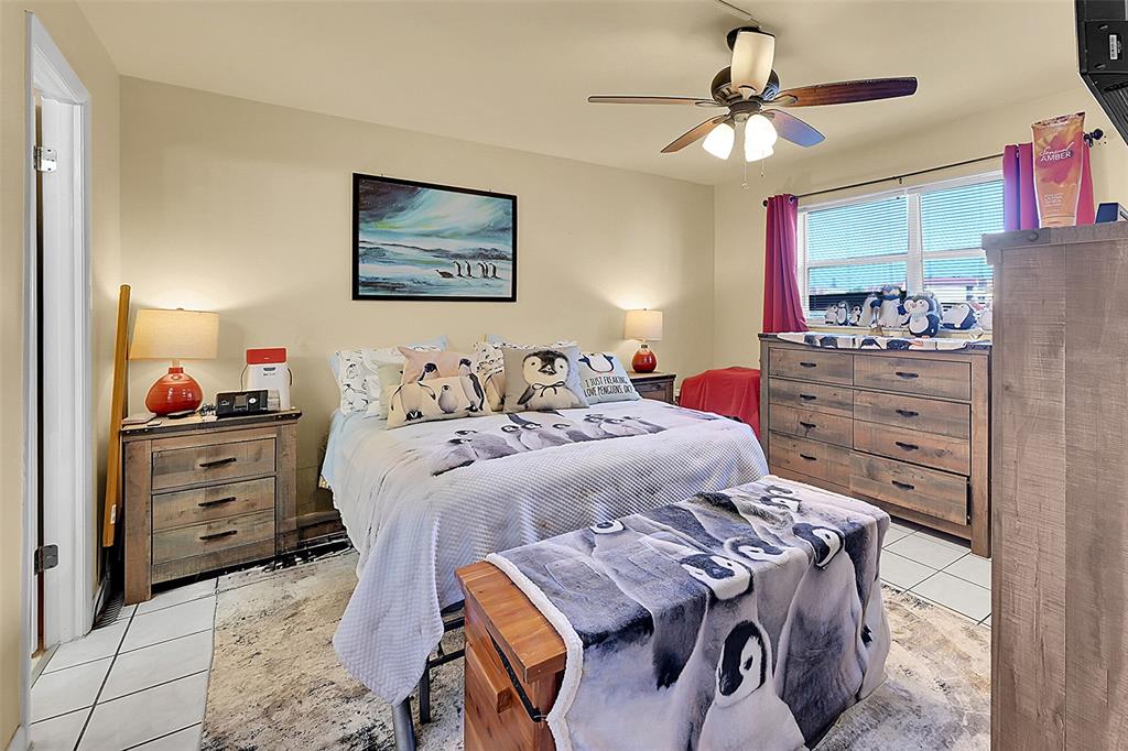 2811 North Pine Island Road, Unit 111 Sunrise, FL 33322 - Photo 5 of 13 a bedroom with a bed and a dresser in it