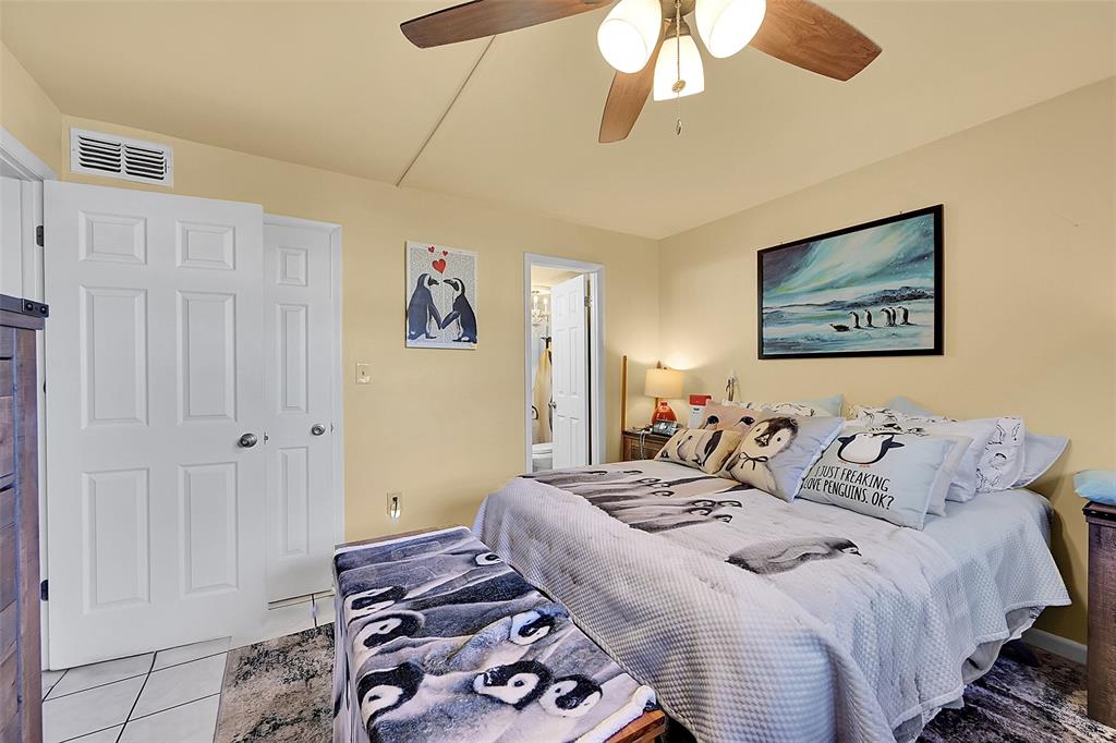 2811 North Pine Island Road, Unit 111 Sunrise, FL 33322 - Photo 6 of 13 a bed room with a bed and a painting on the wall