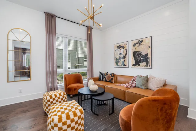 a living room with furniture and wooden floor