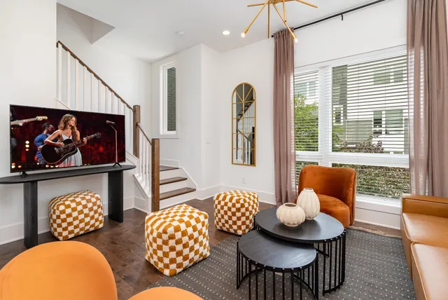 a living room with furniture and a floor to ceiling window