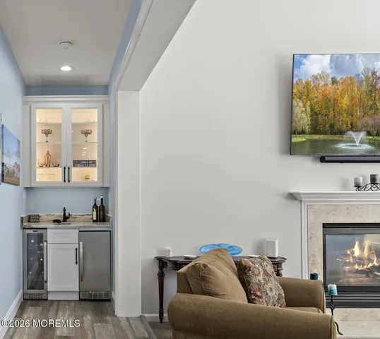 a dining room with furniture a chandelier and wooden floor