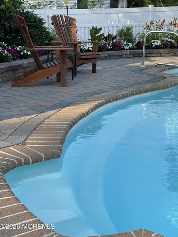 a living room with wooden floor and a table