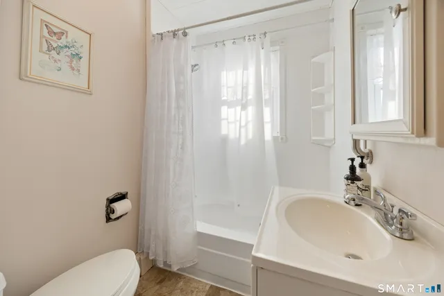 a bathroom with a sink toilet and shower