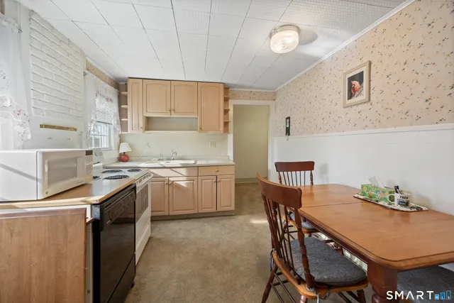 a kitchen that has a table and chairs in it