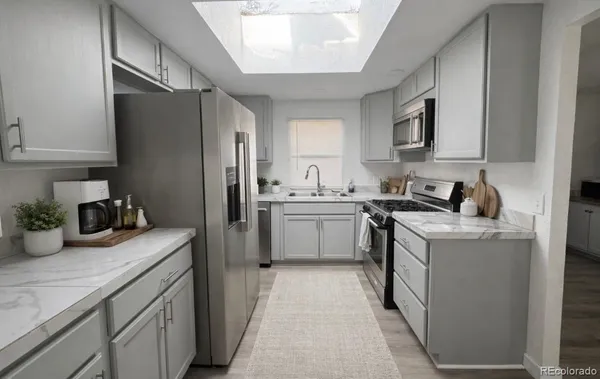 a kitchen with a sink stove and refrigerator