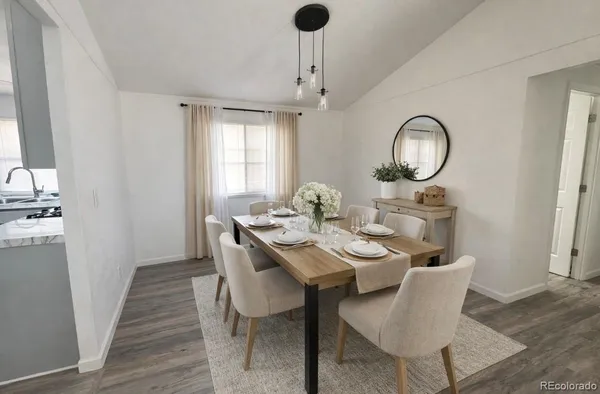a dining room with wooden floor a chandelier a wooden table and chairs