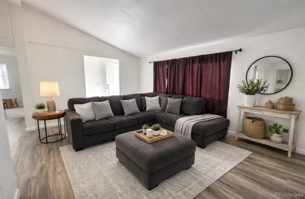 a living room with furniture a fireplace and a window