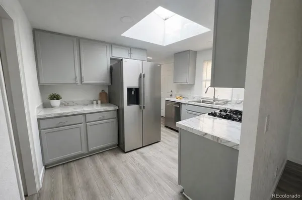 a kitchen with a refrigerator sink and stove