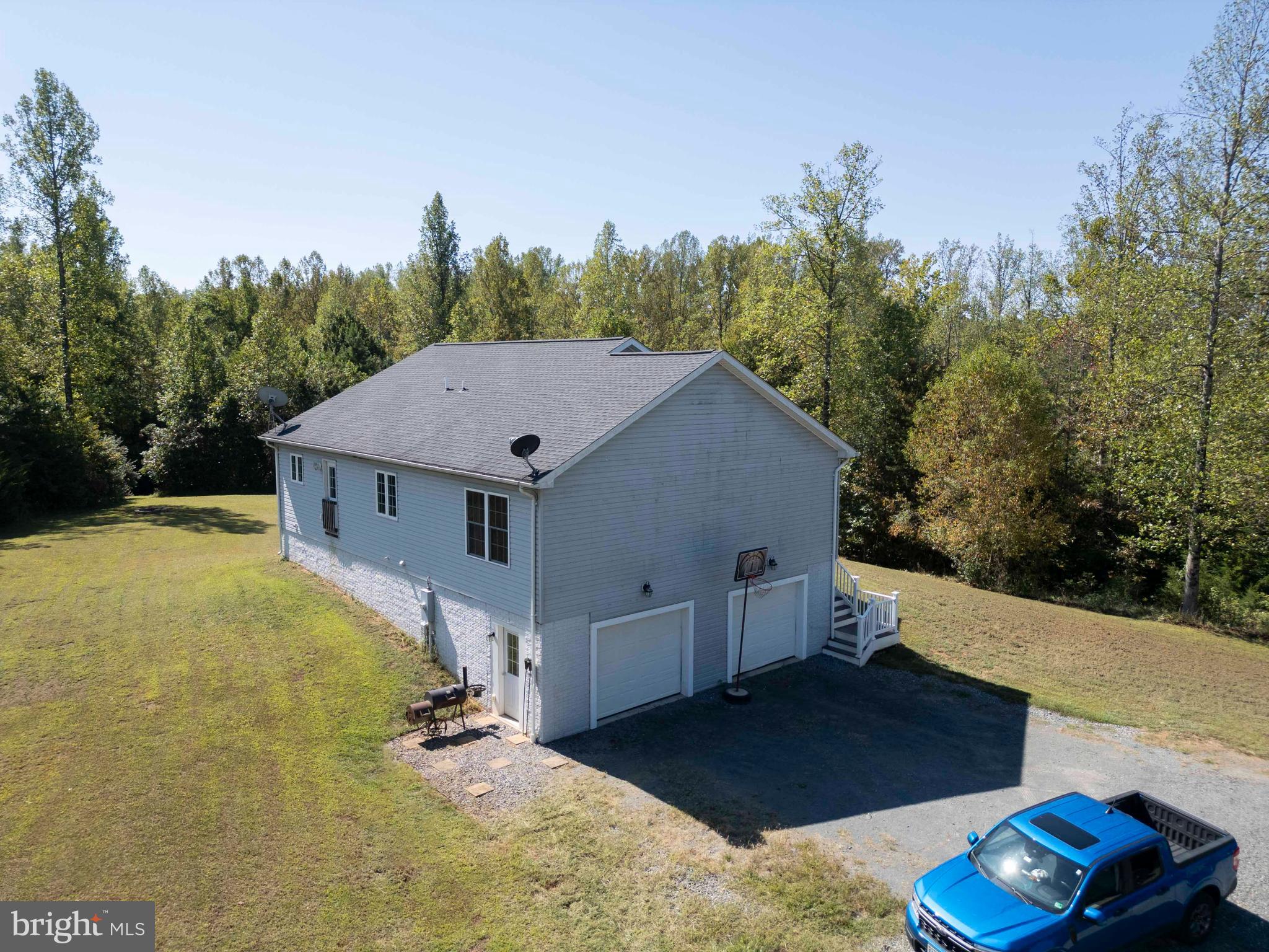 21281 Old Mill Road Culpeper, VA 22701 - Photo 13 of 40 a view of a house with backyard and trees in the background