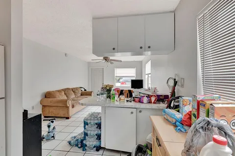 a living room with furniture toys and a window