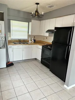 a kitchen with a sink a stove and refrigerator
