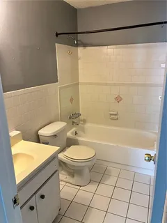 a bathroom with a toilet a sink and bathtub