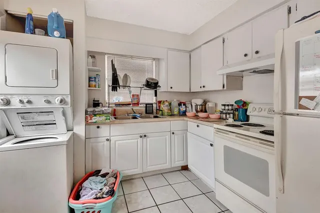 a kitchen with cabinets appliances and a sink