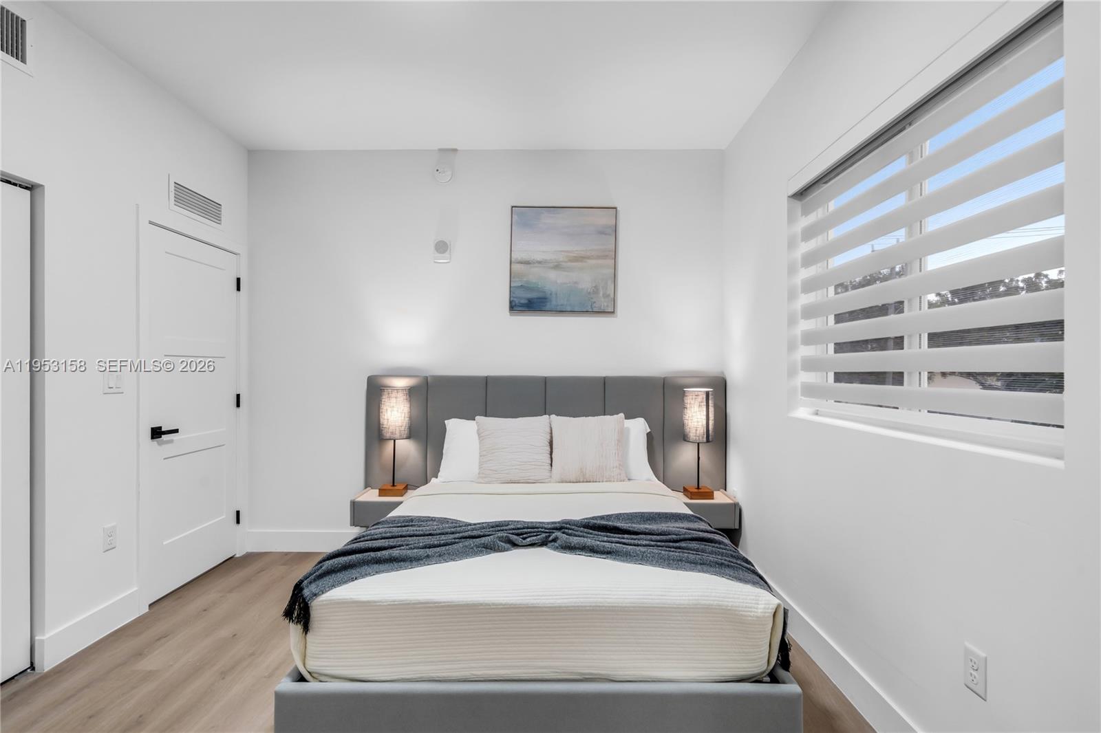 3728 Northwest 19th Avenue, Unit 304 Miami, FL 33142 - Photo 13 of 26 a bedroom with a bed and a window