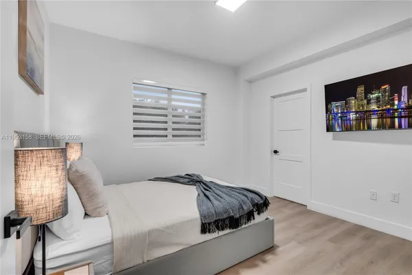 a bed sitting in a bedroom next to a window