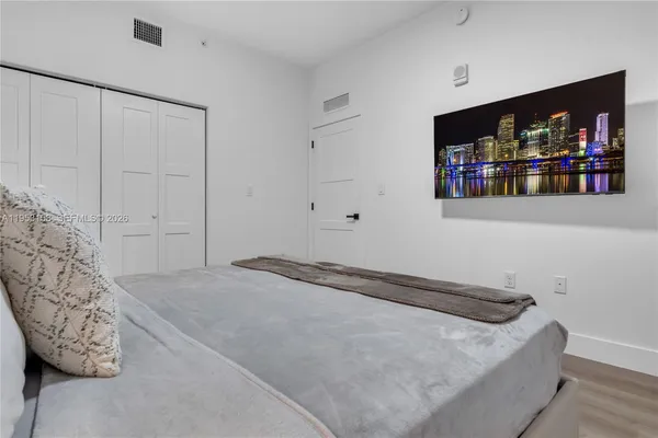 a bedroom with a bed and a couch