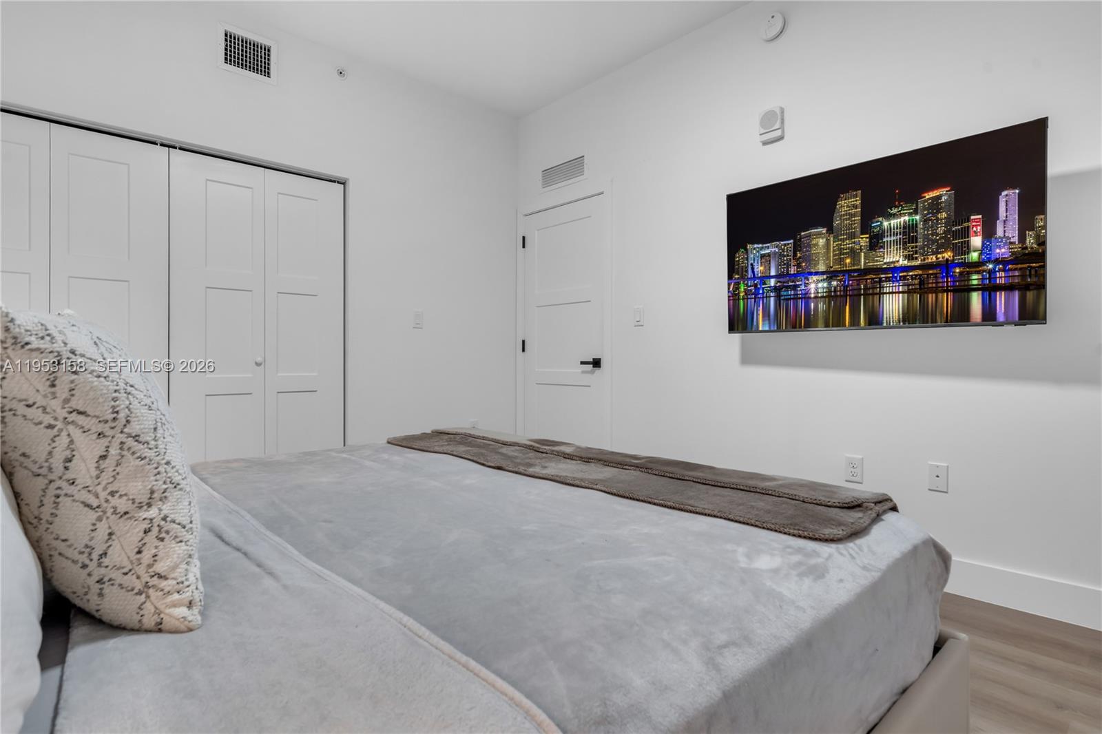 3728 Northwest 19th Avenue, Unit 304 Miami, FL 33142 - Photo 17 of 26 a bedroom with a bed and a couch