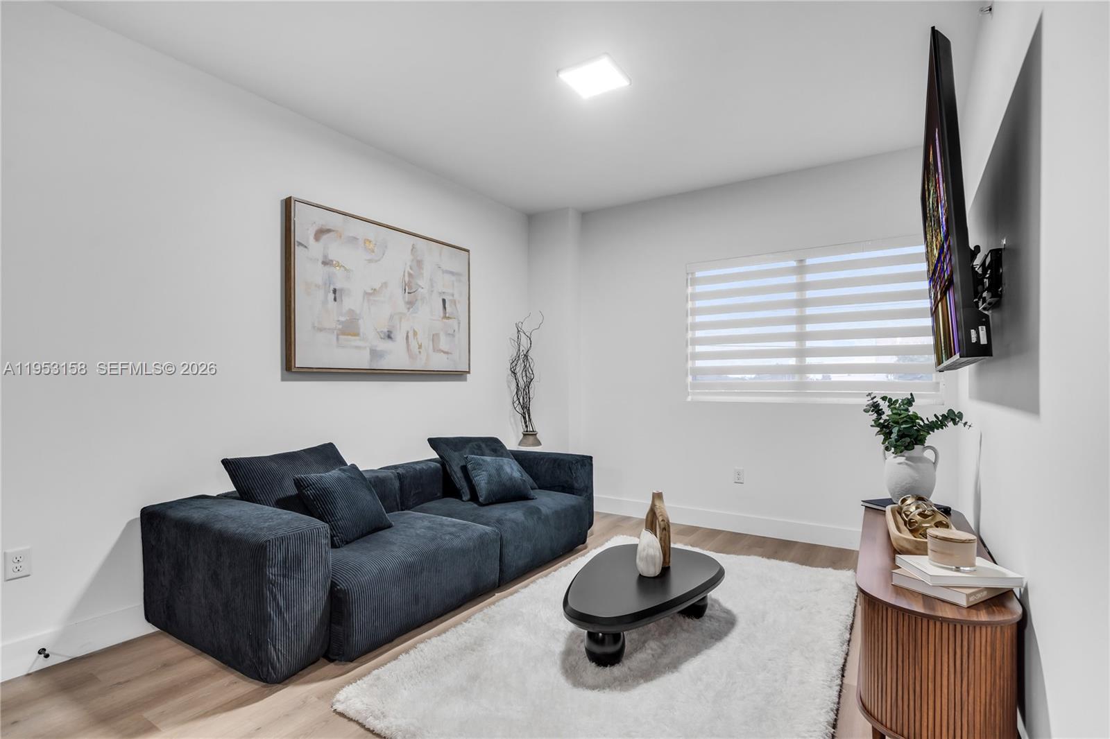 3728 Northwest 19th Avenue, Unit 304 Miami, FL 33142 - Photo 2 of 26 a living room with furniture and a window