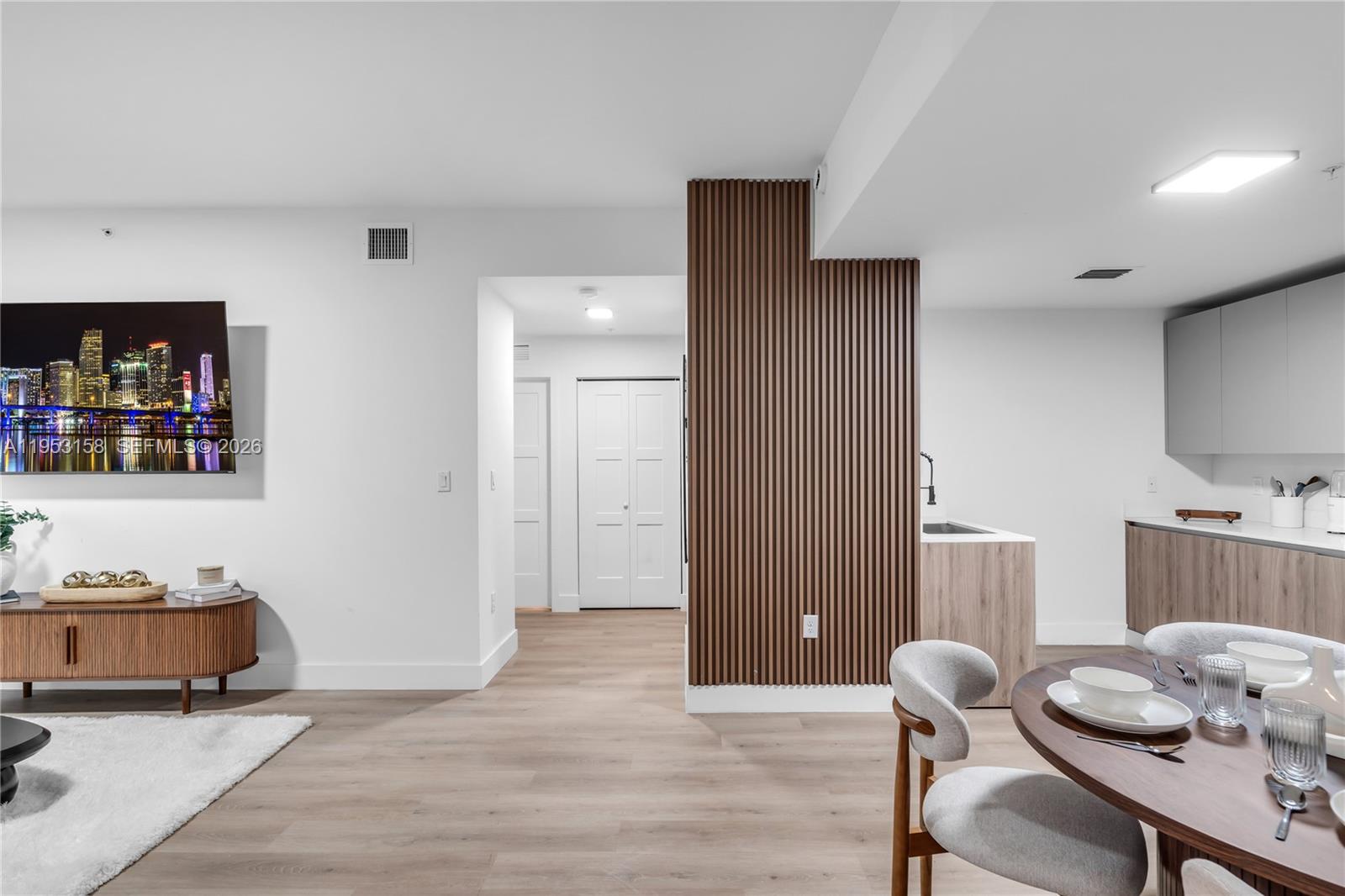 3728 Northwest 19th Avenue, Unit 304 Miami, FL 33142 - Photo 7 of 26 a living room with furniture and wooden floor