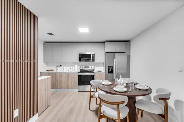a kitchen with stainless steel appliances kitchen island granite countertop a sink and cabinets