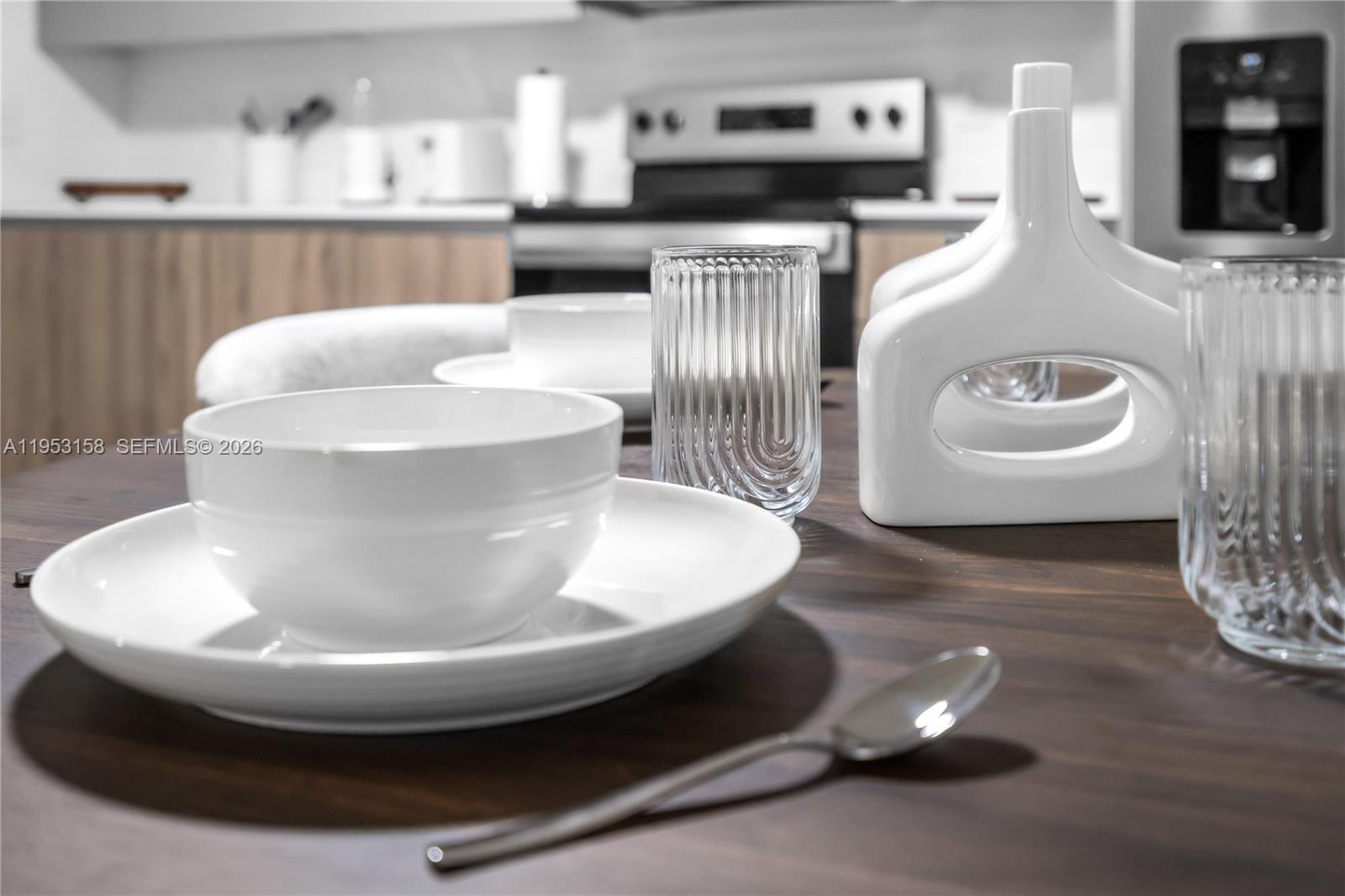 3728 Northwest 19th Avenue, Unit 304 Miami, FL 33142 - Photo 10 of 26 a view of kitchen with stainless steel appliances granite countertop a sink and white cabinets