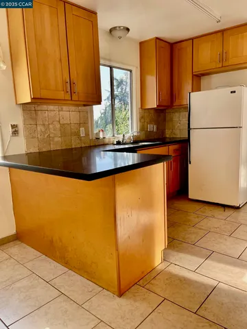 a kitchen with sink a window and cabinets