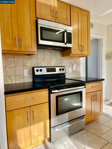a kitchen with sink a window and cabinets