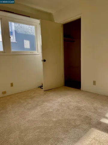 an empty room with closet area