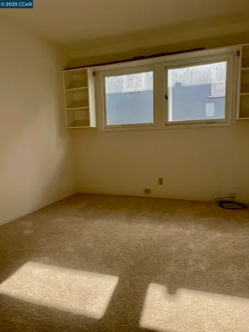 an empty room with closet area