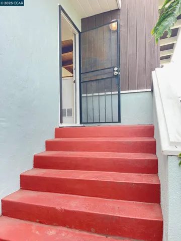 a view of an empty room with a fireplace
