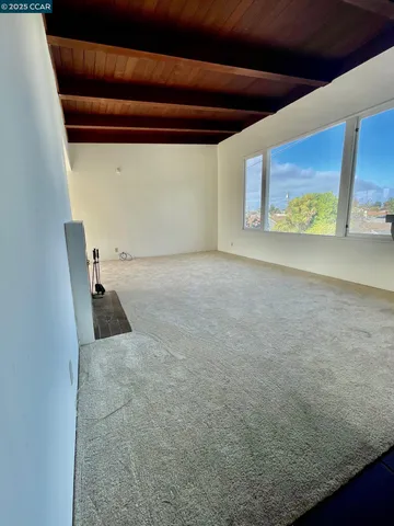 a view of an empty room with a fireplace