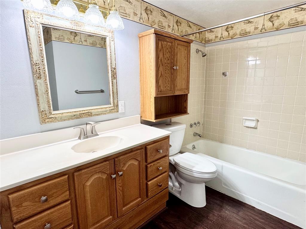 4014 Ridglea Country Club Drive, Unit 407 Fort Worth, TX 76126 - Photo 15 of 26 a bathroom with a granite countertop sink toilet and shower