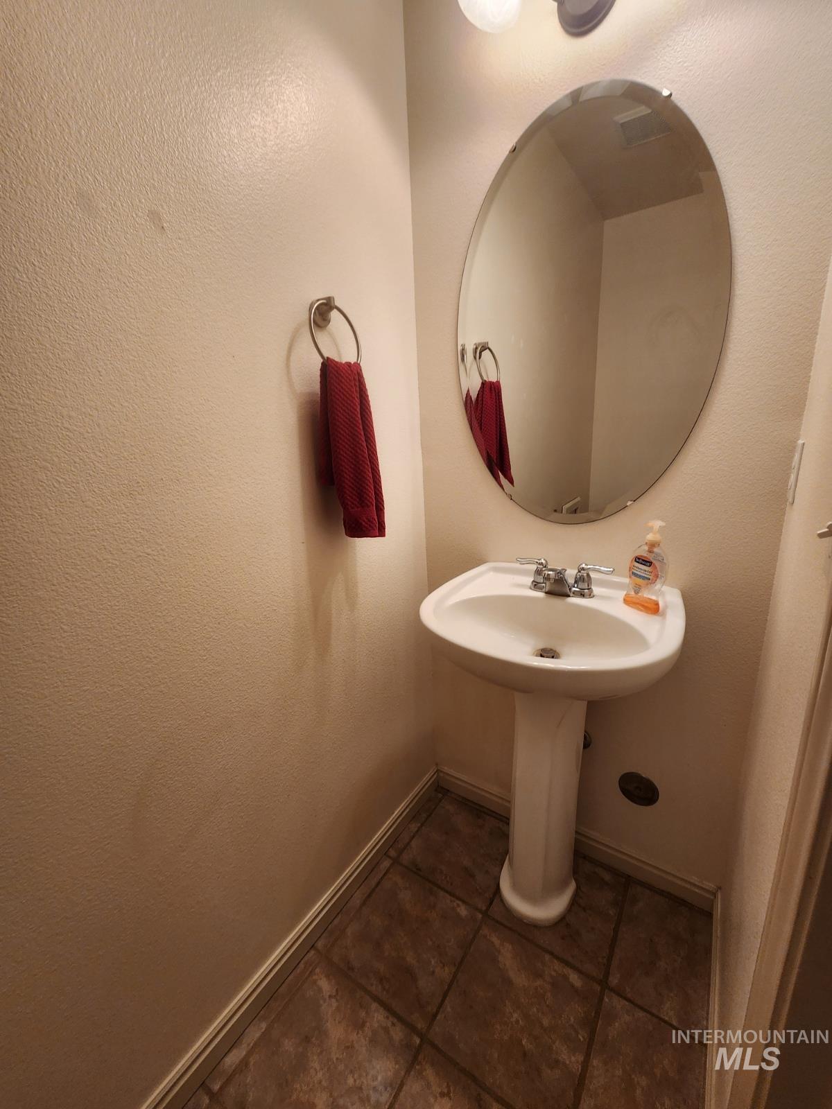 1000 North Rodeo Street Parma, ID 83660 - Photo 22 of 35 Bathroom with dark tile patterned floors and a textured wall