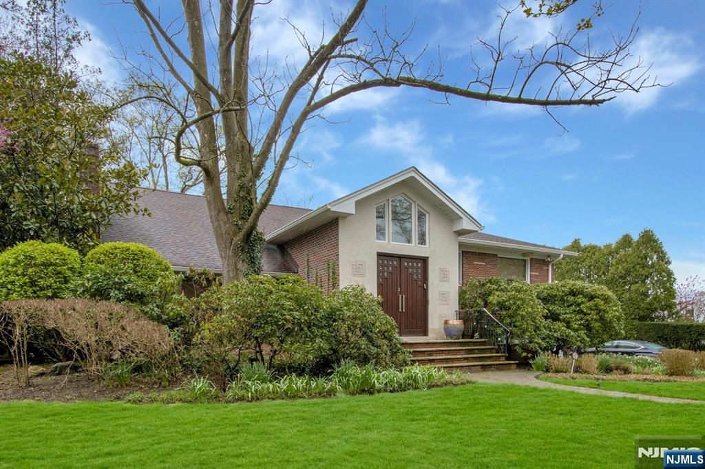 278 Fountain Road Englewood, NJ 07631 - Photo 3 of 37 a front view of a house with a yard