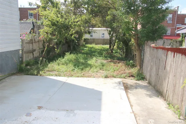a backyard of a house with a yard and outdoor seating