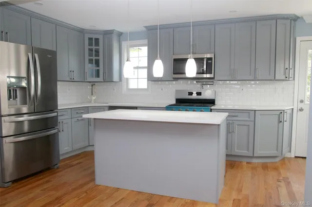 a kitchen with a refrigerator sink and microwave