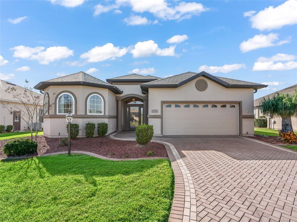 16896 South East 110th Court Road Summerfield, FL 34491 - Photo 3 of 61 a view of front of a house with a garden and yard