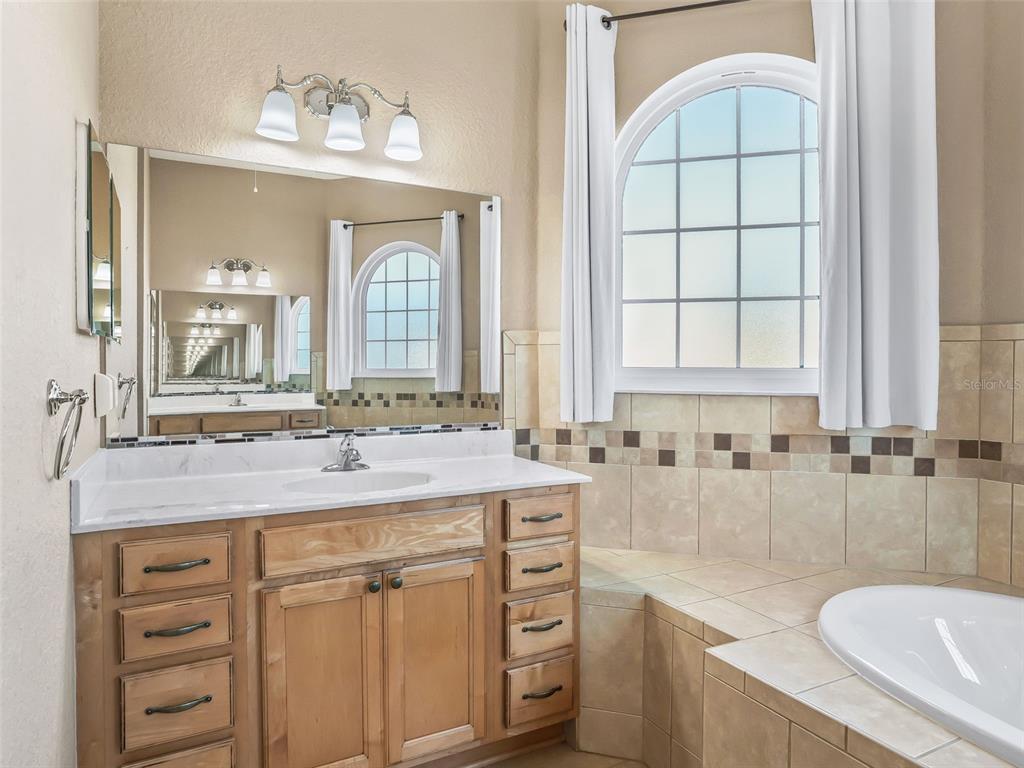 16896 South East 110th Court Road Summerfield, FL 34491 - Photo 36 of 61 a bathroom with a granite countertop sink mirror and a