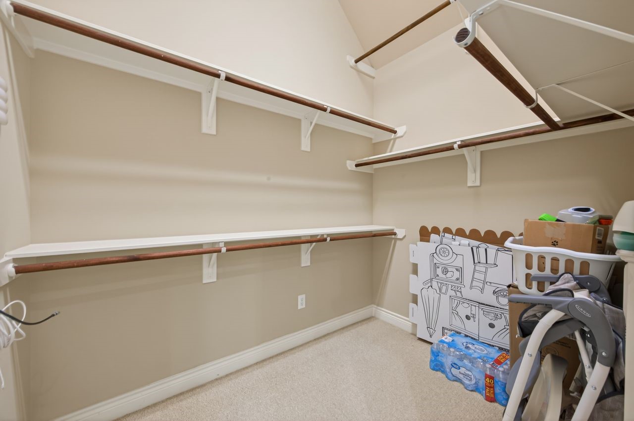 10932 Lasso Lane Houston, TX 77079 - Photo 20 of 38 a view of walk in closet with clothes