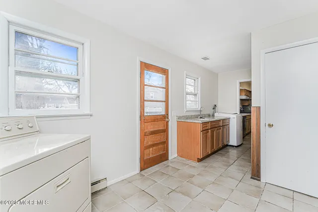 a room with a dresser and a window