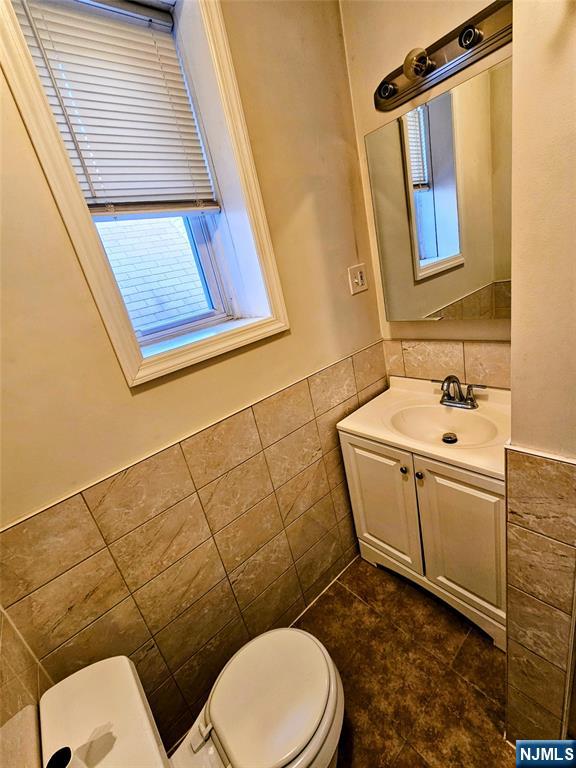 32-34 Halstead Street Kearny, NJ 07032 - Photo 11 of 12 a bathroom with a toilet a sink and mirror