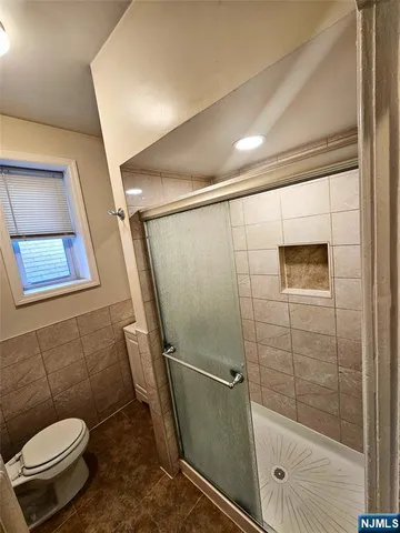 a bathroom with a toilet and a shower