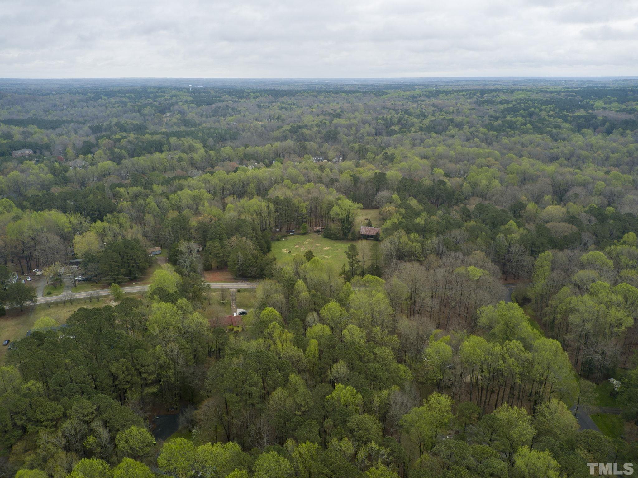 1129 Mt Vernon Church Road Raleigh, NC 27615 - Photo 11 of 11 a view of a field of grass and trees